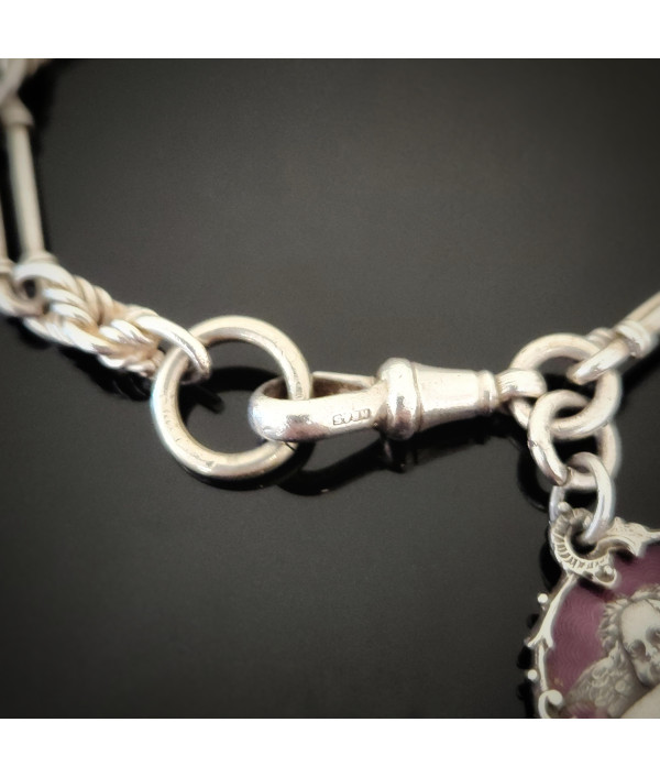 Antique Sterling Silver Trombone and Lover’s Knot Albert Chain Bracelet with Enamelled Cherub Charm Antique Sterling Silver Trombone and Lover’s Knot Albert Chain Bracelet with Enamelled Cherub Charm